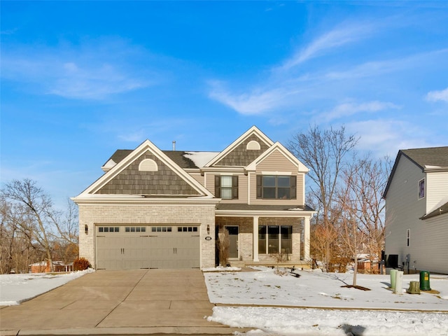 view of front of home with a garage, covered porch, brick siding, and driveway