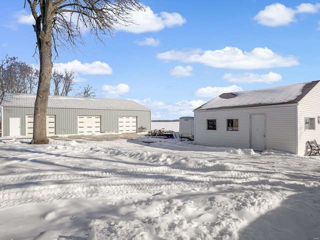 exterior space with a garage and an outbuilding