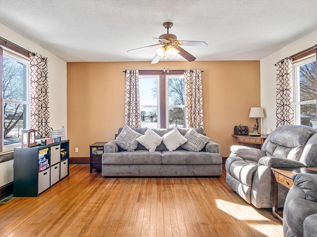 living room featuring a textured ceiling, light hardwood / wood-style flooring, and a healthy amount of sunlight