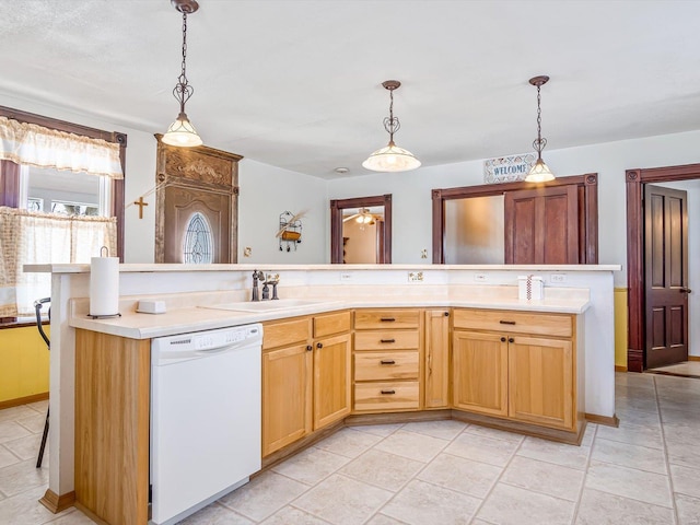 kitchen featuring pendant lighting, sink, a center island with sink, and white dishwasher