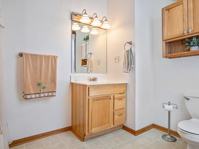 bathroom featuring vanity, tile patterned floors, and toilet