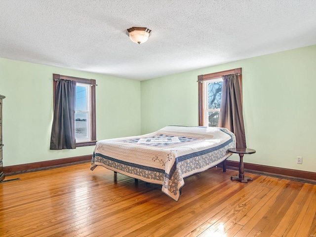 bedroom featuring hardwood / wood-style floors and a textured ceiling