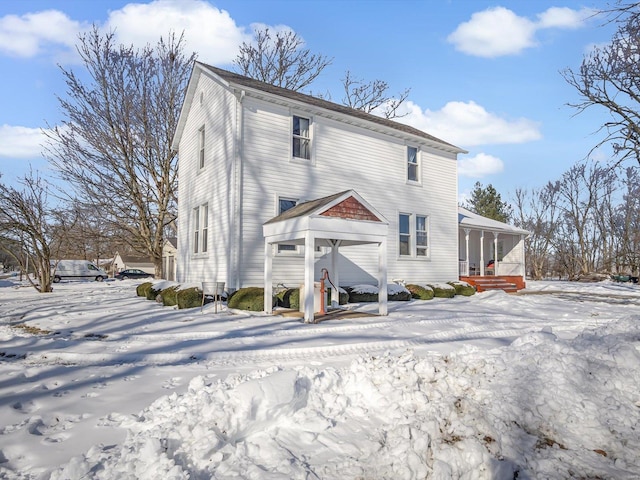 snow covered house with a sunroom