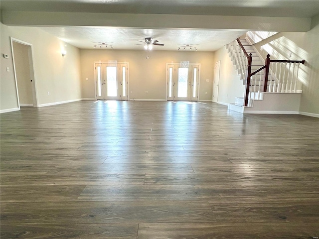 unfurnished living room with ceiling fan and dark hardwood / wood-style floors