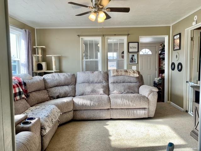 carpeted living area featuring ceiling fan