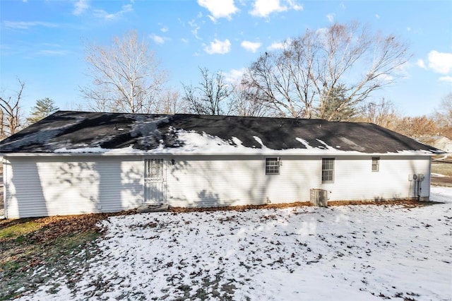 view of snow covered exterior featuring cooling unit