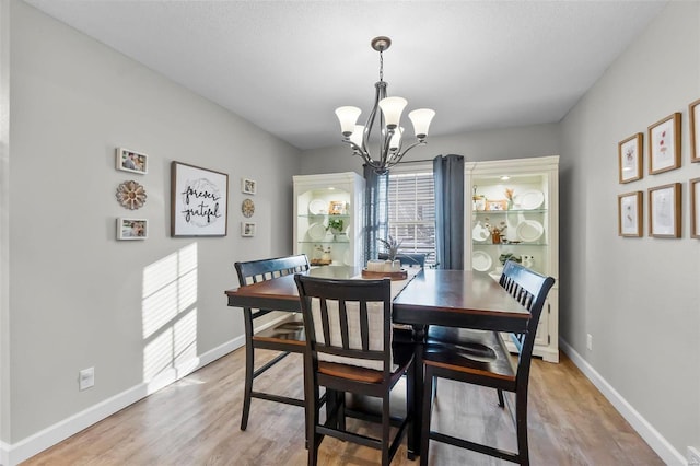 dining room with an inviting chandelier and hardwood / wood-style flooring