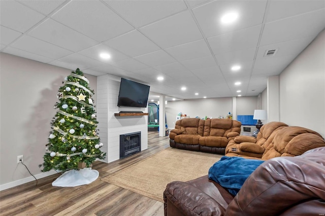 living room featuring a large fireplace and hardwood / wood-style floors