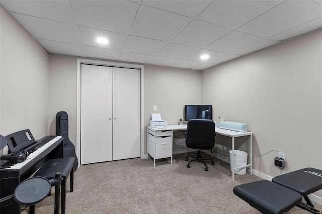 carpeted home office featuring a drop ceiling