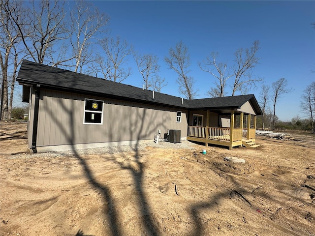 rear view of house featuring central air condition unit and a deck