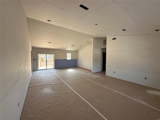 unfurnished living room featuring vaulted ceiling