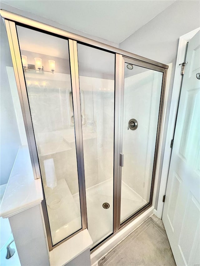 bathroom with a shower with door