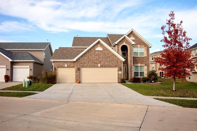 view of front of home featuring a front lawn and a garage