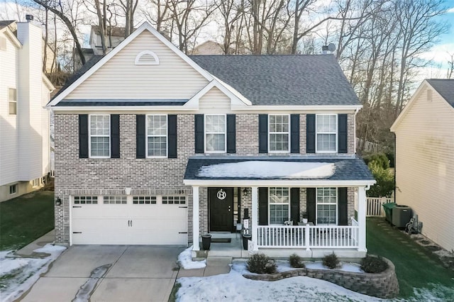 view of property featuring a garage and covered porch