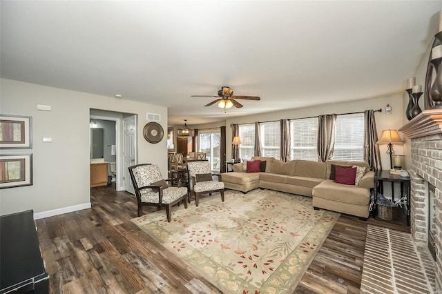 living room with a fireplace, dark hardwood / wood-style floors, and ceiling fan