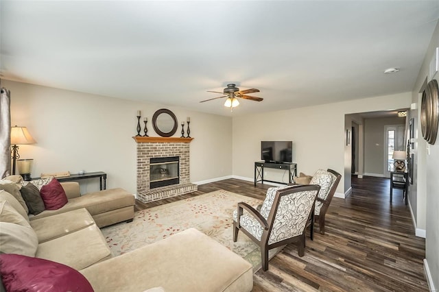 living room with ceiling fan, dark hardwood / wood-style floors, and a fireplace