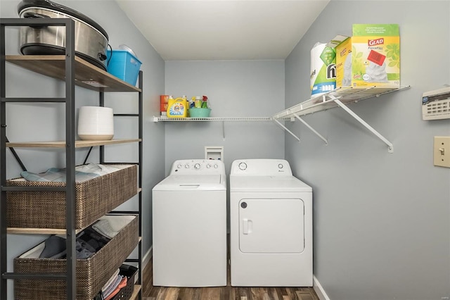 laundry area featuring separate washer and dryer and dark hardwood / wood-style flooring