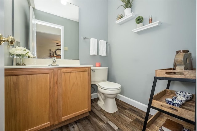 bathroom featuring vanity, hardwood / wood-style floors, and toilet