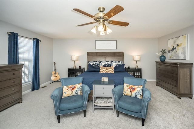 bedroom with ceiling fan and light colored carpet