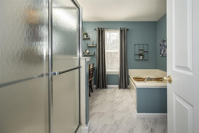 bathroom featuring separate shower and tub