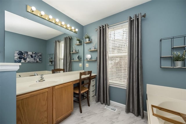 bathroom featuring vanity and a tub to relax in