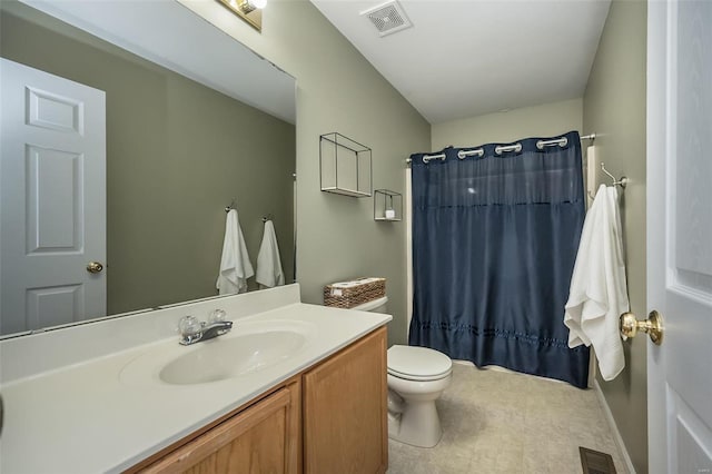 bathroom featuring vanity, walk in shower, and toilet