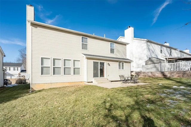 back of house with a yard and a patio area