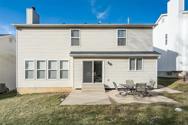 rear view of house featuring central AC unit, a patio area, and a lawn