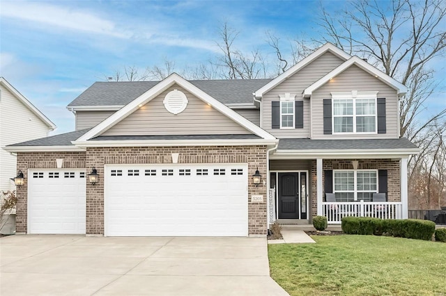 view of front of house with a porch, a garage, and a front lawn