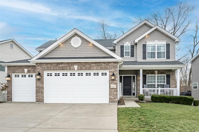 view of front of house with a garage, a porch, and a front lawn