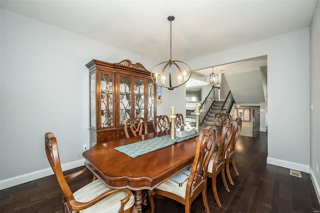 dining room featuring dark hardwood / wood-style floors and a notable chandelier