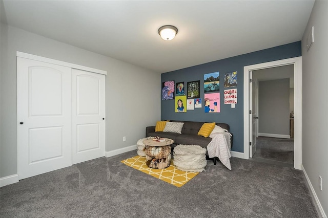 sitting room featuring dark colored carpet