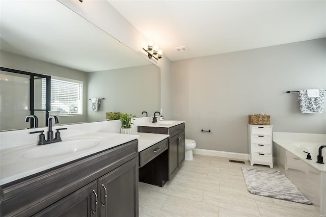 bathroom featuring vanity, a bath, and toilet