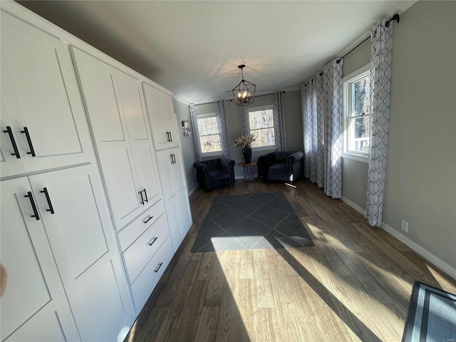 unfurnished room featuring dark hardwood / wood-style floors and an inviting chandelier