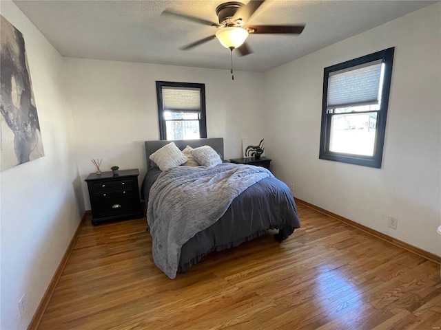 bedroom featuring ceiling fan and light hardwood / wood-style floors