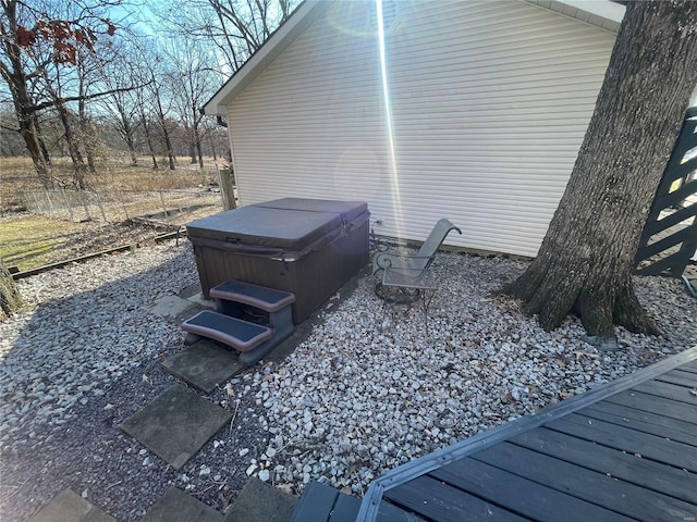 view of side of property featuring a hot tub