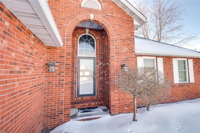 view of snow covered property entrance