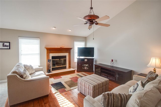 living room featuring ceiling fan, vaulted ceiling, plenty of natural light, and light hardwood / wood-style flooring