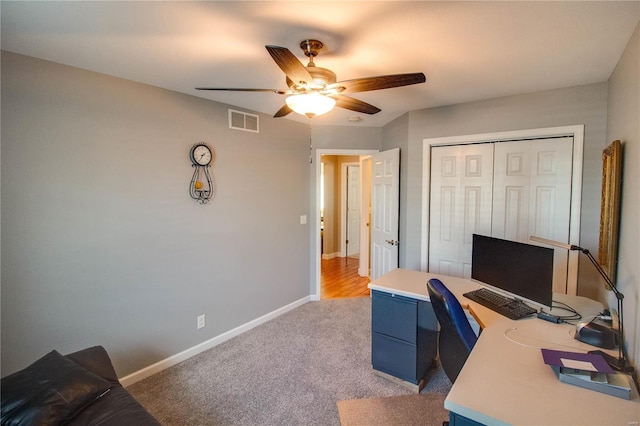 carpeted home office with ceiling fan