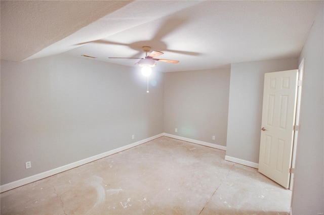 empty room featuring a textured ceiling, ceiling fan, and lofted ceiling