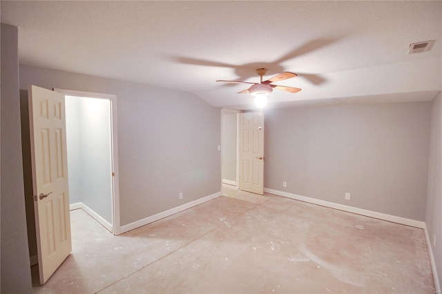 empty room featuring ceiling fan and vaulted ceiling