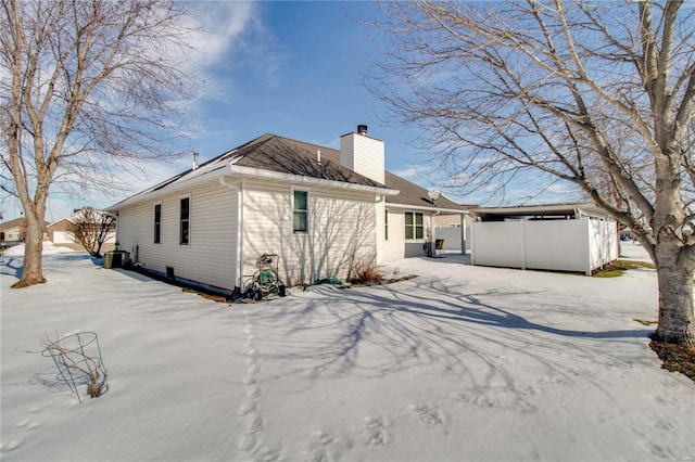 snow covered property featuring central air condition unit