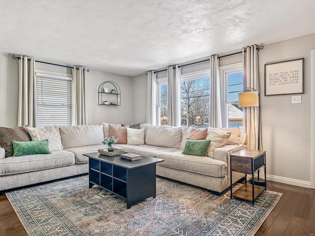 living room featuring a textured ceiling and dark hardwood / wood-style flooring