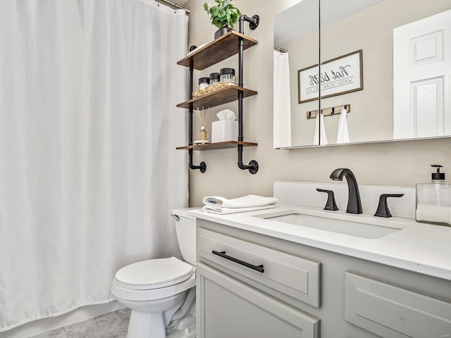 bathroom with toilet, tile patterned floors, and vanity