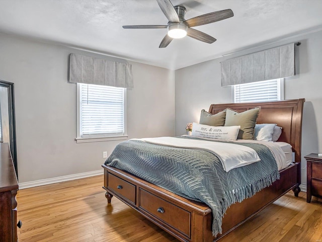 bedroom with ceiling fan and light hardwood / wood-style flooring