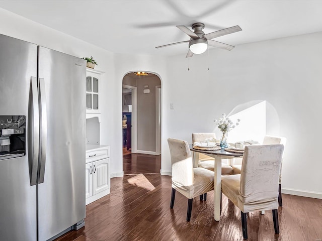 dining room with ceiling fan and dark hardwood / wood-style flooring