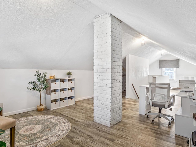 office space with hardwood / wood-style floors, a textured ceiling, and vaulted ceiling