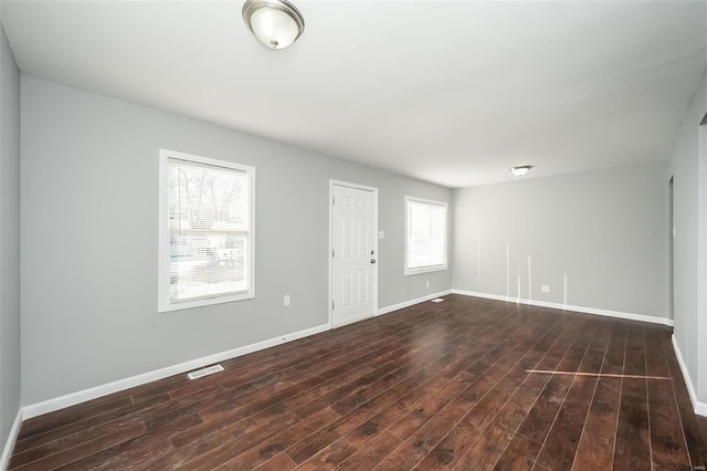 spare room featuring dark wood-type flooring