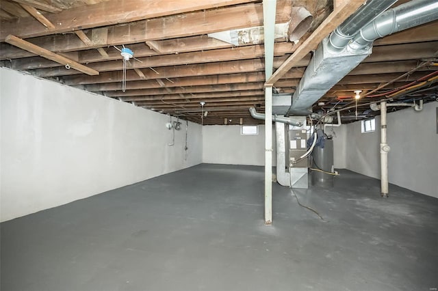 basement featuring heating unit and gas water heater