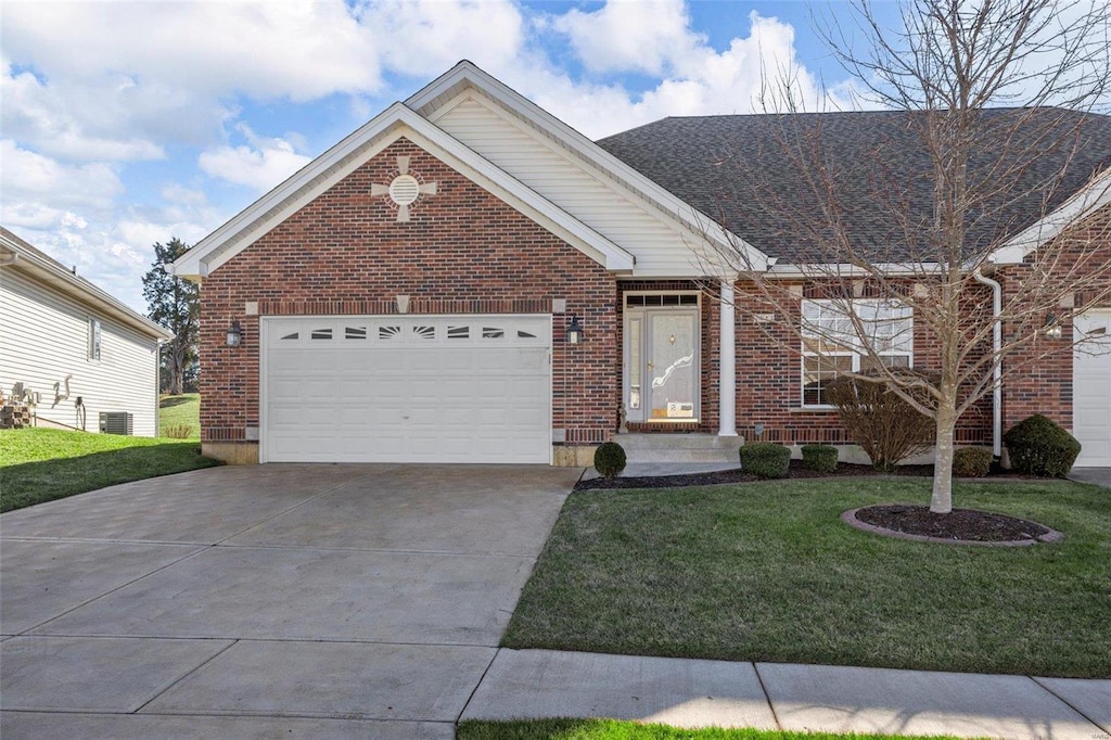 view of front of house featuring a front yard, central AC, and a garage